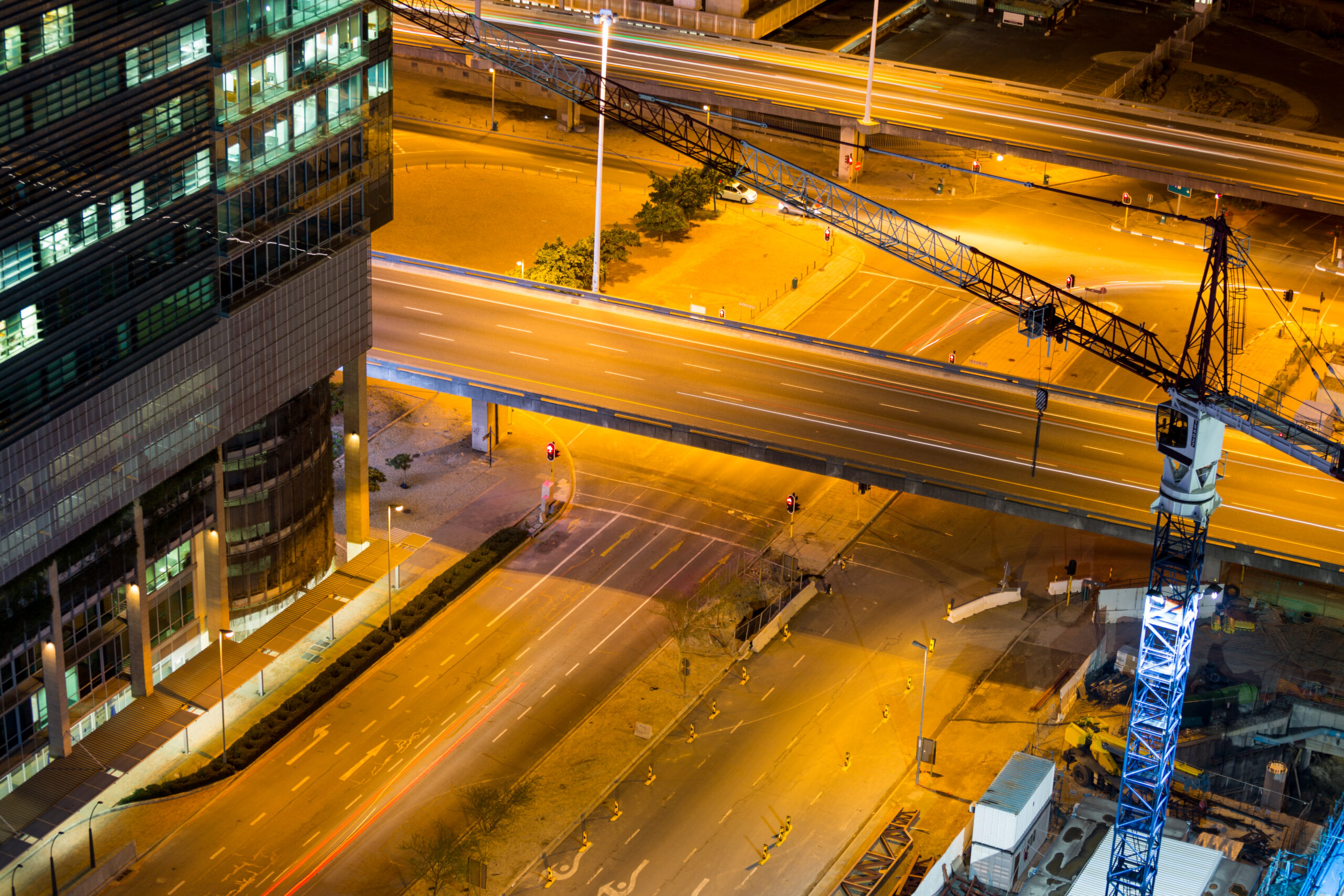 aerial view of streets and office building in business district at night
