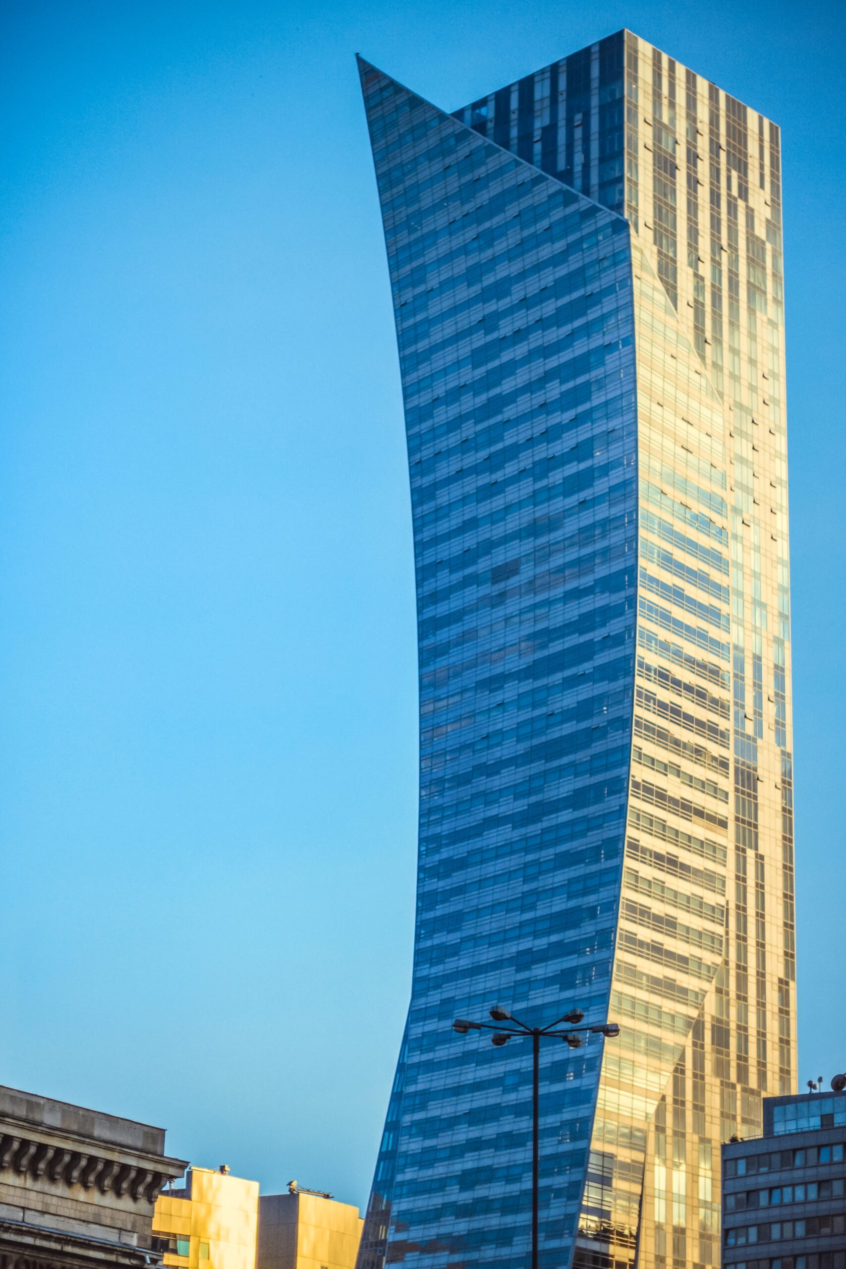 vertical shot of a large skyscraper under the blue sky
